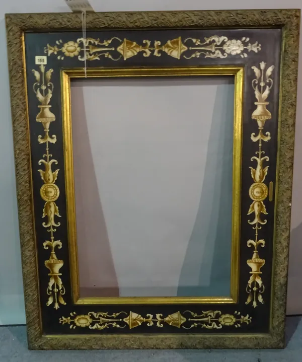 A 20th century painted frame with classical decoration, aperture 50cm x 70.4cm and a pair of brass lamps, each 35cm tall.