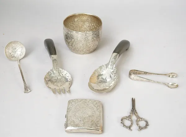 Silver, comprising; a Victorian sugar bowl, having scroll engraved decoration, London 1887, a sugar sifting spoon, a pair of sugar tongs and a cigaret