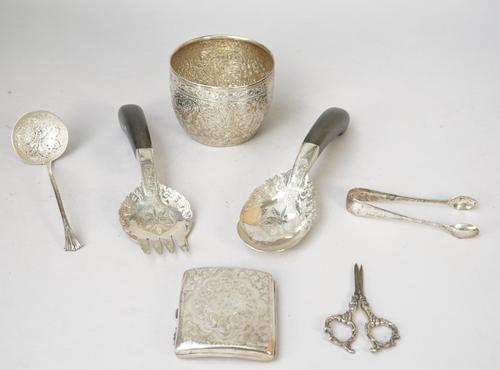 Silver, comprising; a Victorian sugar bowl, having scroll engraved decoration, London 1887, a sugar sifting spoon, a pair of sugar tongs and a cigaret