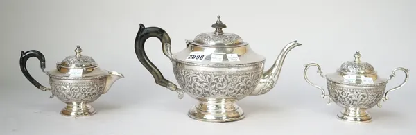 An Asian three piece tea set, comprising; a teapot and a lidded milk jug, having black fittings and a lidded twin handled sugar bowl, each piece of ci