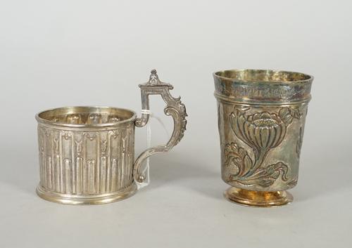 A Dutch beaker, of tapered cylindrical form, the band at the top inscribed in Cyrilic style lettering, otherwise with floral decoration to the body, b