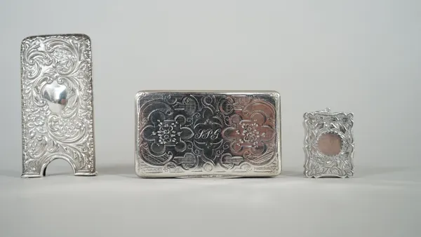 A Victorian silver shaped rectangular vinaigrette, with foliate engraved decoration, maker Hilliard & Thomason, Birmingham 1879, a late Victorian silv