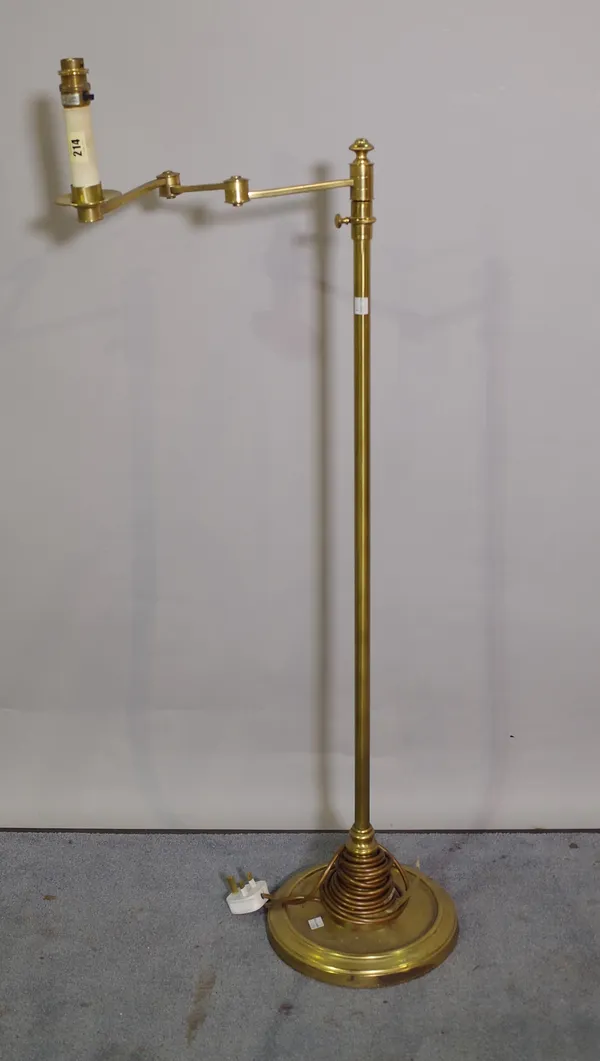 A 20th century brass adjustable standard lamp on circular plinth base, 107cm high.