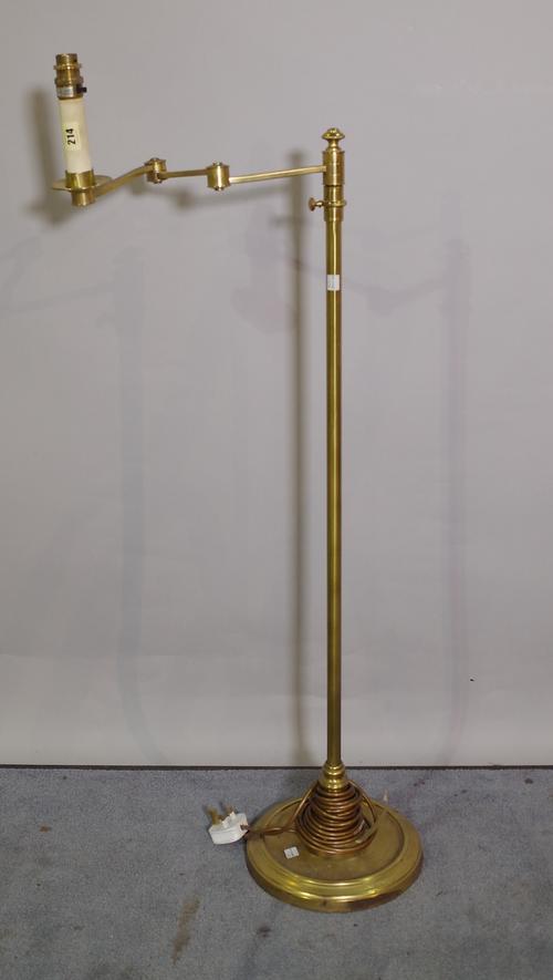 A 20th century brass adjustable standard lamp on circular plinth base, 107cm high.