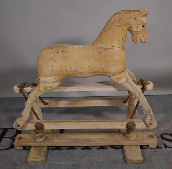 An early 20th century pine rocking horse, 80cm wide x 84cm high, (a.f.).