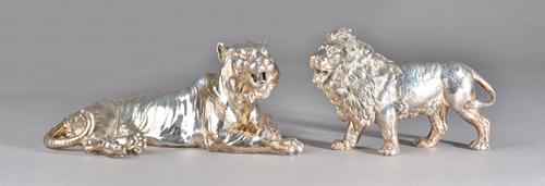 A silver model of a standing male lion (loaded), length 19cm and a silver model of a tiger lying down (loaded), length 24cm, (2).