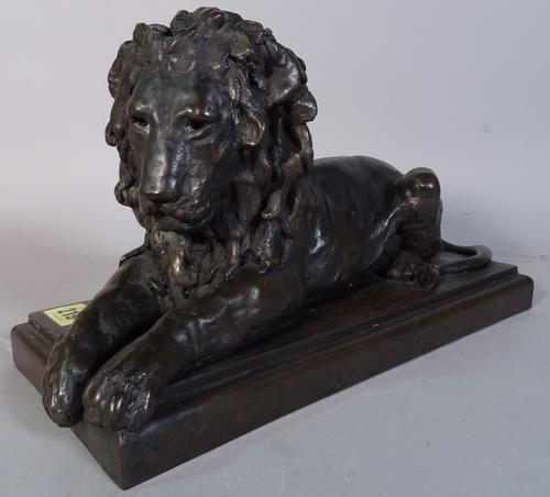 Ronald Moll limited edition bronzed figure of recumbent lion on rectangular base, signed and numbered 71/750 (height 18cm length 32cm), a black slate