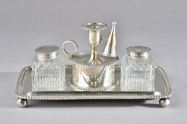 A George III silver twin bottle inkstand, of rectangular form, having decorated edges, raised on four spherical feet, fitted with two silver mounted f