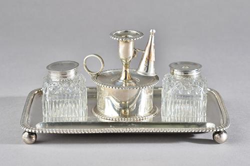 A George III silver twin bottle inkstand, of rectangular form, having decorated edges, raised on four spherical feet, fitted with two silver mounted f