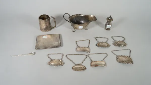 Silver, comprising; a rectangular cigarette case, London 1935, a sauceboat, Sheffield 1933, a christening mug and a decanter label detailed Whisky, co