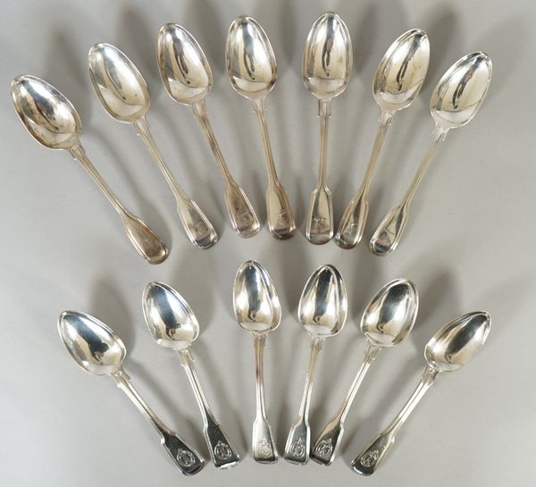 Thirteen silver double struck fiddle and thread pattern dessert spoons, engraved with differing crests, mixed dates, weight 640 gms, (13).