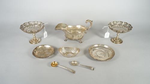 Silver, comprising; a pair of pedestal bonbon dishes, having pierced decoration below shaped circular rims, Birmingham 1920, a sauceboat decorated wit