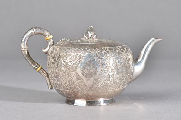 A Victorian silver teapot, of compressed circular form, the body decorated with birds amidst blossom, monogram engraved, the hinged lid with a frog fi