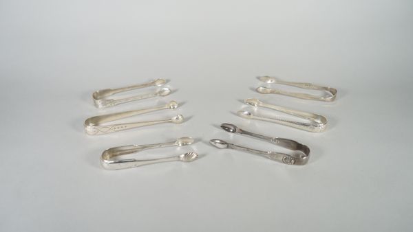 Two pairs of Irish silver sugar tongs, with bright cut engraved decoration, circa 1800, a pair of silver sugar tongs, London 1826 and three further pa