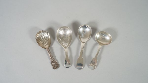 A Victorian silver caddy spoon, having a shell shaped bowl, the single struck handle cast with fruiting vine, London 1873 and three silver fiddle patt