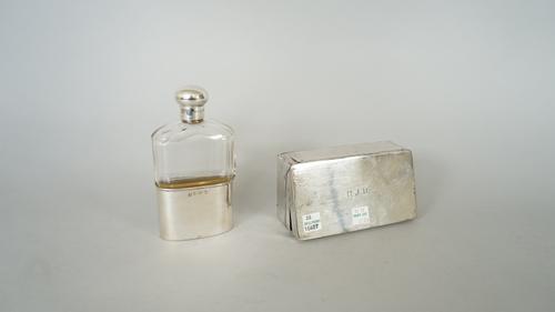 A silver mounted, faceted glass spirit flask, with a pull-off beaker base, Birmingham 1903 and a silver rectangular folding sandwich box, the lid init