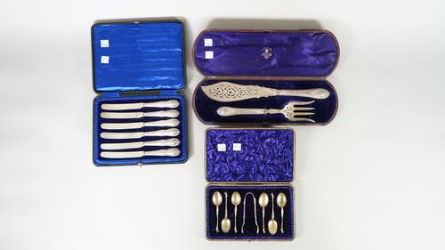 A pair of Victorian silver fish servers, with engraved and pierced decoration and with loaded silver handles, Sheffield 1874, cased, six similar silve