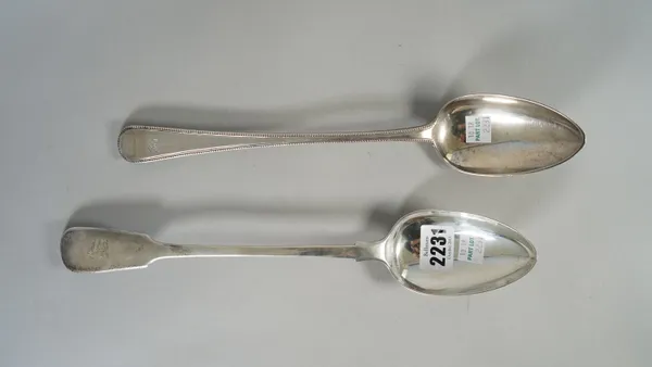 A silver fiddle pattern basting spoon, crest engraved, London 1834 and a silver single struck, bead edged, Old English pattern basting spoon, monogram