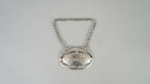 A silver decanter label, detailed Port, of oval form, with pierced and engraved decoration, struck with the maker's mark only for Hester Bateman, circ