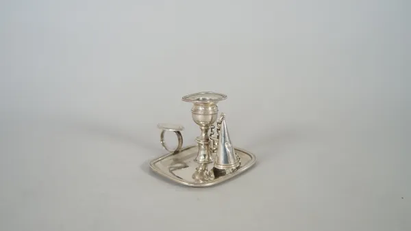 A George IV silver small chamber candlestick, of curved rectangular form, with a loop shaped handle and a detachable snuffing cone, fitted to a chain,