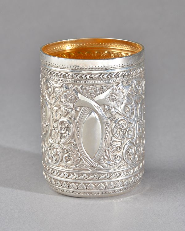 A Victorian Scottish silver beaker, of cylindrical form with embossed floral and scrolling decoration, gilt within, height 9.5cm, Glasgow 1879, weight