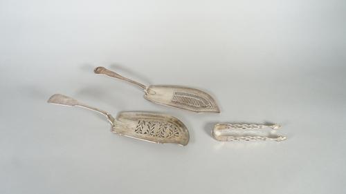 Silver, comprising; a George IV fiddle pattern fish slice, pierced and engraved with three fish, otherwise decorated with a foliate spray, London 1828