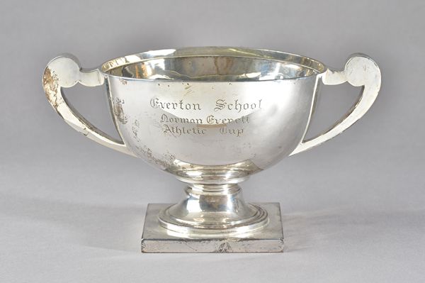 A silver twin handled trophy bowl, raised on a square foot, presentation inscribed, Birmingham probably 1918, weight 842 gms.