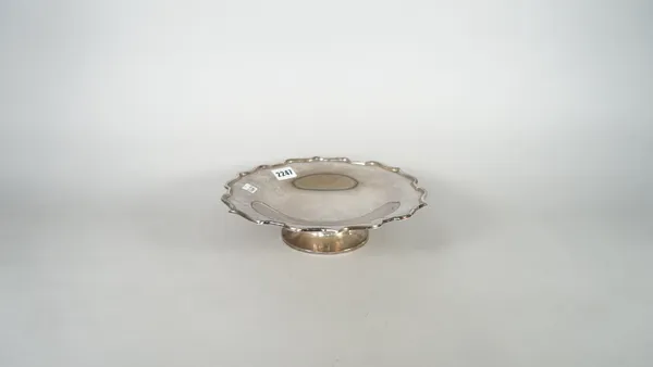 A silver pedestal dish, decorated with a shaped rim in the Chippendale style, raised on a circular foot, diameter 25.5cm, Chester 1937, weight 389 gms