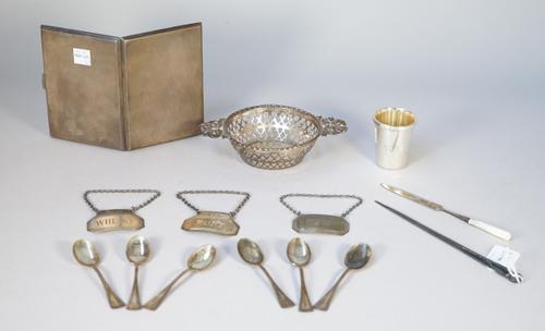 Silver, comprising; a rectangular cigarette case with engine turned decoration, Birmingham 1941, a twin handled bonbon dish, three decanter labels det