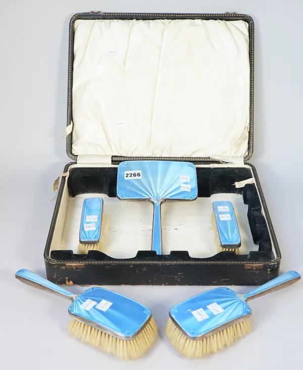 A group of mostly silver and blue enamel mounted lady's dressing table wares, comprising; two hair brushes and two clothes brushes, Birmingham 1929 an