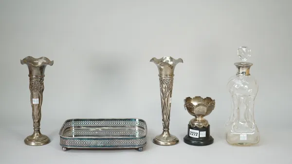 Silver and silver mounted wares, comprising; a twin handled trophy bowl with a black stand, Birmingham 1934, a pair of vases with embossed decoration,