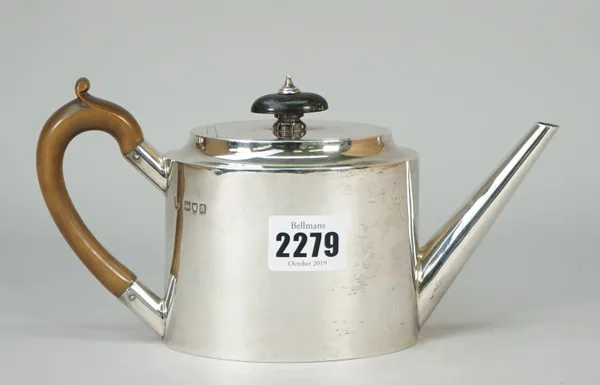 A late Victorian silver teapot of oval form, with a straight tapered spout, London 1896, with wooden fittings, gross weight 309 gms.