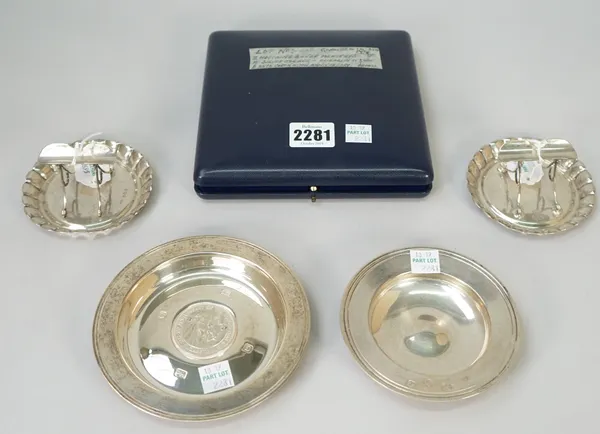 Silver, comprising; a pair of Victorian ashtrays with cigarette rests, London 1895, a circular dish, the centre mounted with a medallion, commemoratin