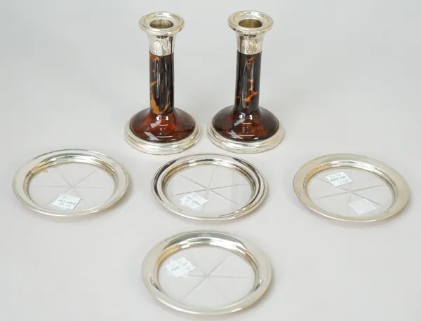 A pair of silver mounted tortoiseshell small candlesticks, raised on circular loaded bases, Birmingham 1921, height 11.5cm and a set of four sterling