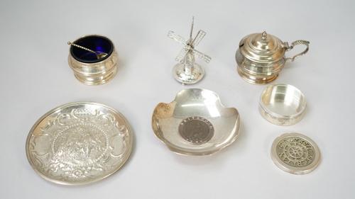 Silver and silver mounted wares, comprising; a model of a windmill, import mark London 1903, a mustard pot and a matching salt, with blue glass liners