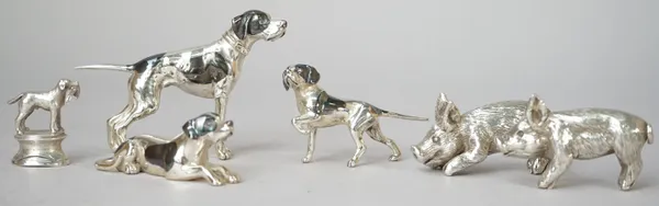 A group of silver models of animals, comprising; two pigs and three dogs in various positions, also a place name or menu holder, modelled as a dog wit