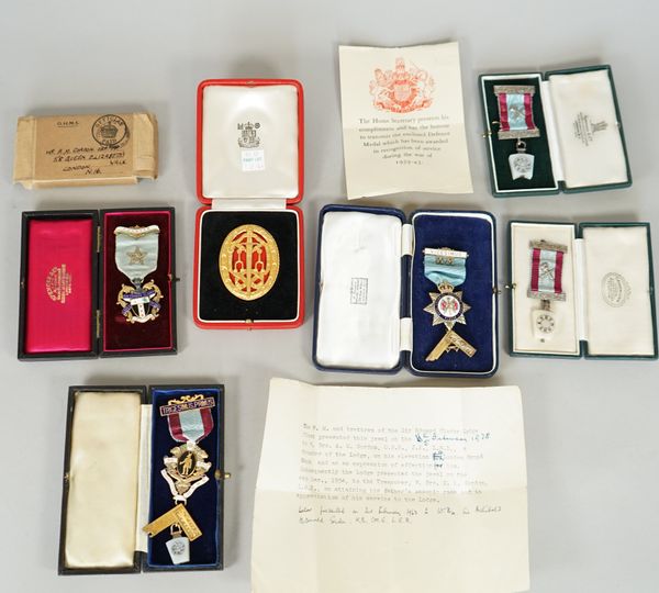 A silver gilt and red enamelled Knight Batchelor's badge, London 1958, with a Royal Mint case, five Masonic jewels with five cases and the forwarding