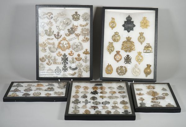 A collection of mostly British Army cap and other badges, mostly re-strikes, displayed in three large and two smaller cases, (5 cases).