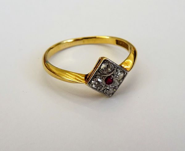 A gold and platinum, diamond and ruby set five stone square cluster ring, mounted with the cushion shaped ruby at the centre, in a surround of four ci