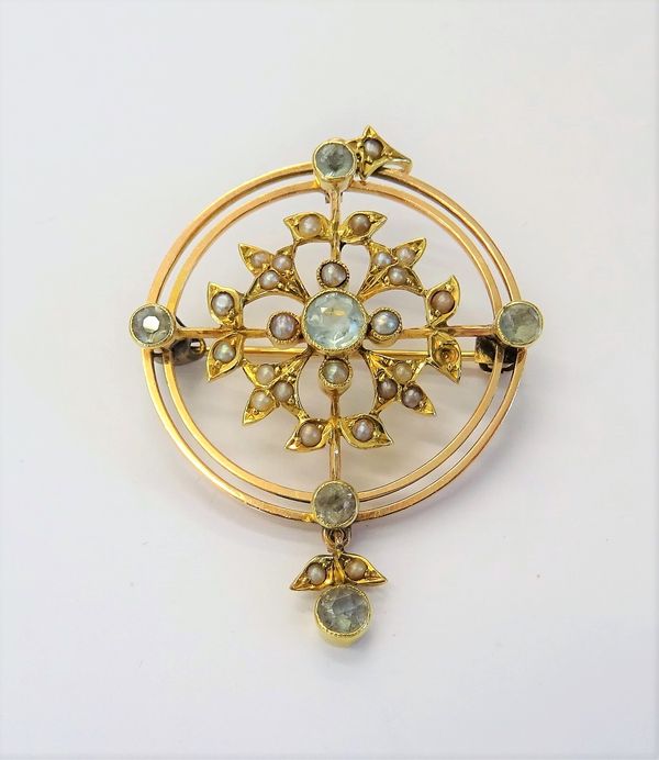 A gold, aquamarine and seed pearl set pendant brooch, in a circular openwork design, decorated with foliate sprays, detailed 15 CT, (one seed pearl la