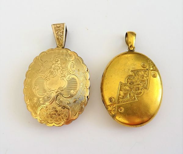 A Victorian gold back and front, shaped oval twin sided pendant locket, with floral and foliate engraved decoration and a Victorian gilt metal oval pe