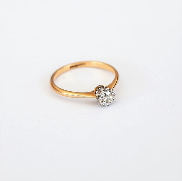 A gold and platinum, diamond set single stone ring, claw set with a cushion shaped diamond detailed 18 CT & PT, ring size N.