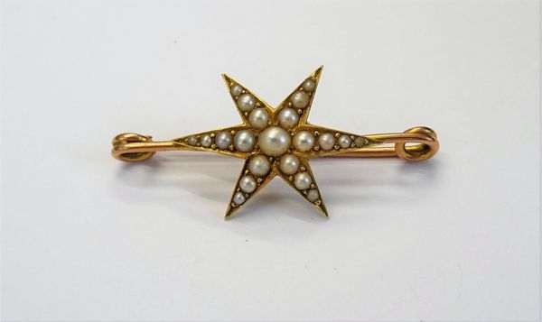 A gold and half pearl set bar brooch, designed as a six pointed starburst, gross weight 5.4 gms.