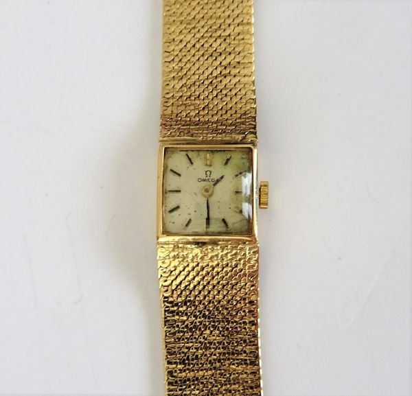 An Omega 9ct gold lady's bracelet wristwatch, the signed square dial with black baton numerals and with black hands, on a woven mesh link bracelet, ha