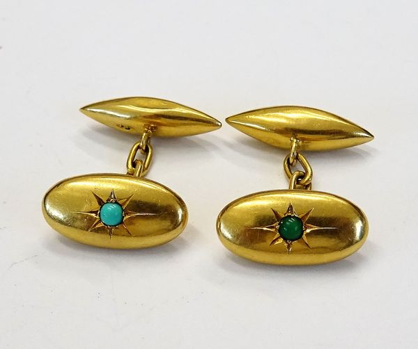 A pair of gold and turquoise set cufflinks, each oval front star set with a circular turquoise and with torpedo shaped backs, detailed 18, gross weigh