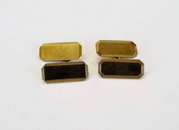 A pair of 9ct gold, cut cornered rectangular cufflinks, the backs and the fronts plain to the centres, within engine turned borders, Birmingham 1944,