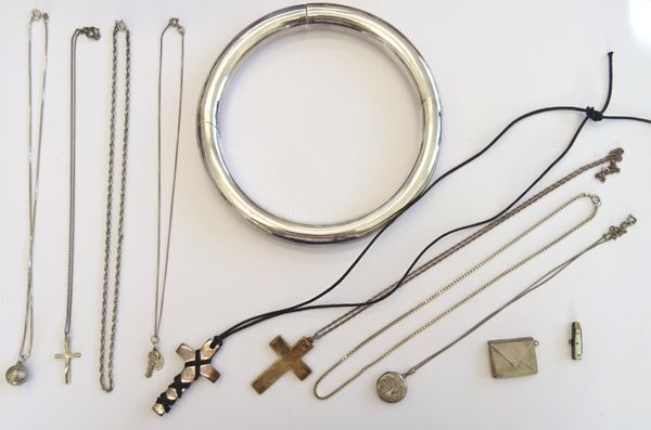 A group of mostly silver jewellery, comprising; a pendant cross fitted to a neckchain, a pendant cross fitted to a cord, a circular hinged collar neck