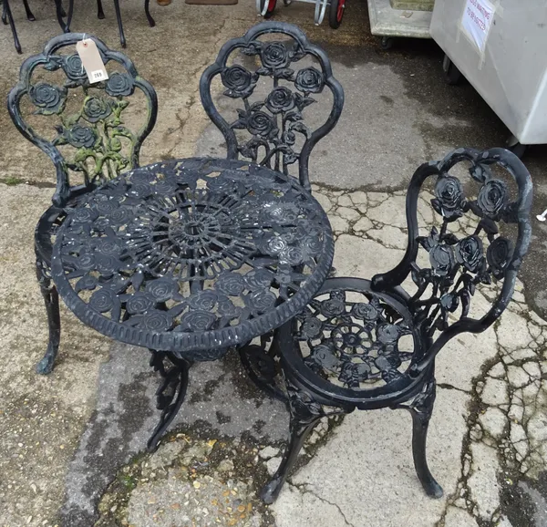 A set of three 20th century black painted cast iron garden chairs with rose decorated back and two matching side tables, 59cm wide x 65cm high, (5).