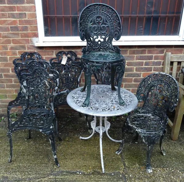 A set of four black painted metal garden chairs, with a matching oval metal garden table, two further chairs and a circular metal garden table, 67cm d