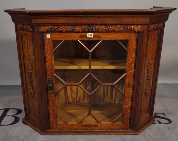 A 20th century carved oak display cabinet with astragal glazed doors, 97cm wide x 74cm high.